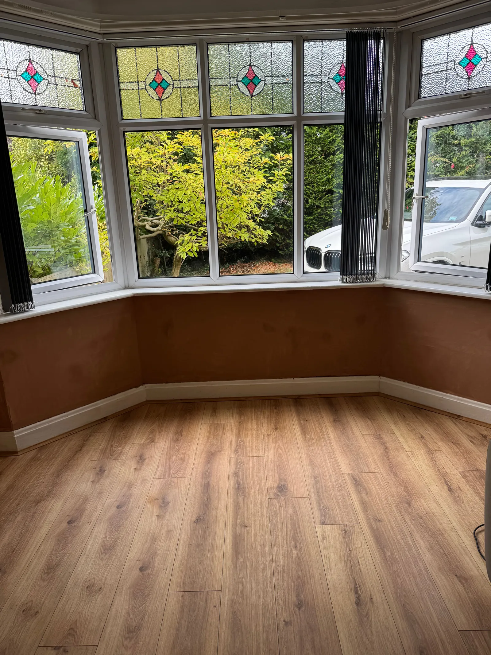 The same bay window wall replastered and finished flat.