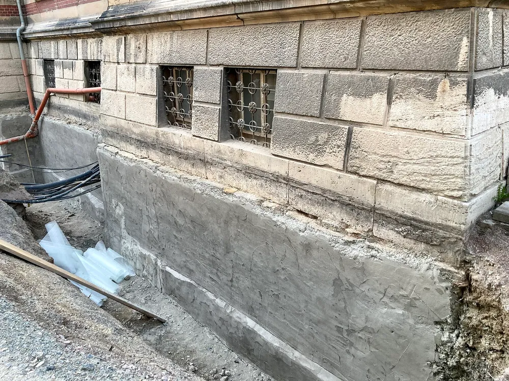 A stone cellar wall dug out and rendered, ready for a waterproof coating